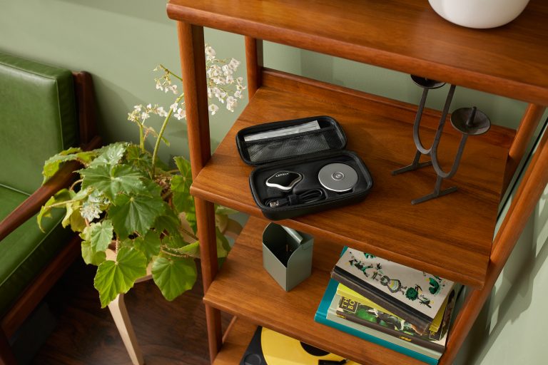 a CEFALY device is sitting on a wooden shelf