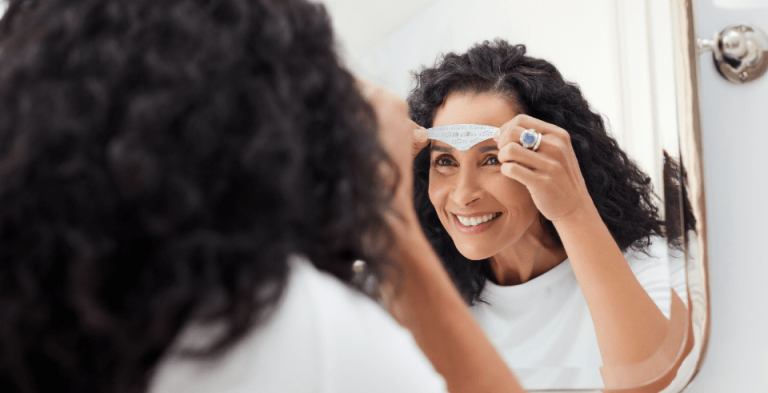 a woman putting on CEFALY electrode