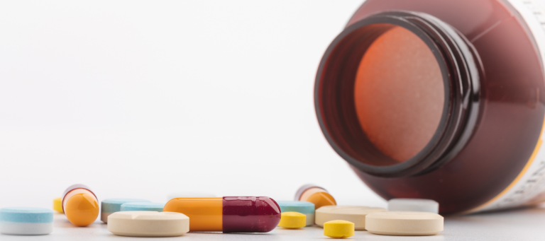 a bottle of pills is spilling out onto a table