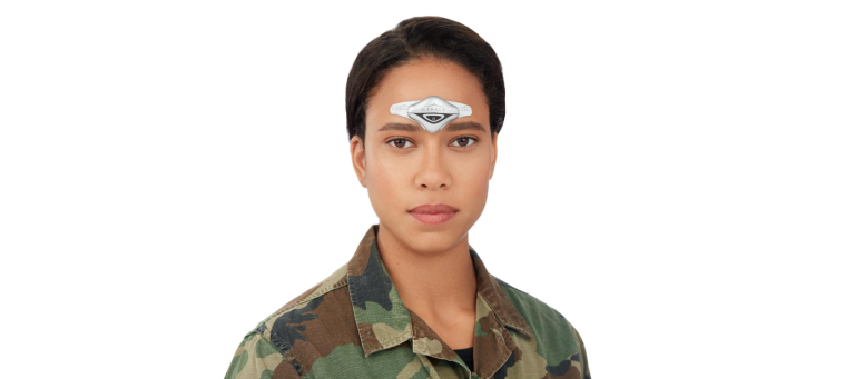 a woman in a military uniform has a CEFALY migraine treatment device on her forehead